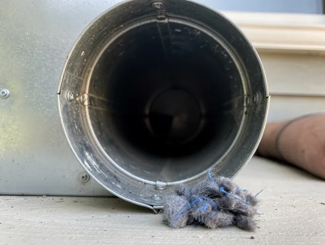 Seven Hills Dryer Vent Cleaning technician using specialized equipment to clear severe dryer vent blockage in Seven Hills